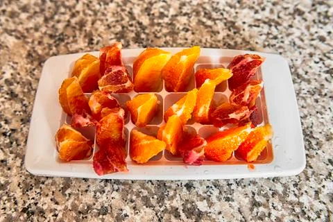 Orange slice in plastic container Stock Photos