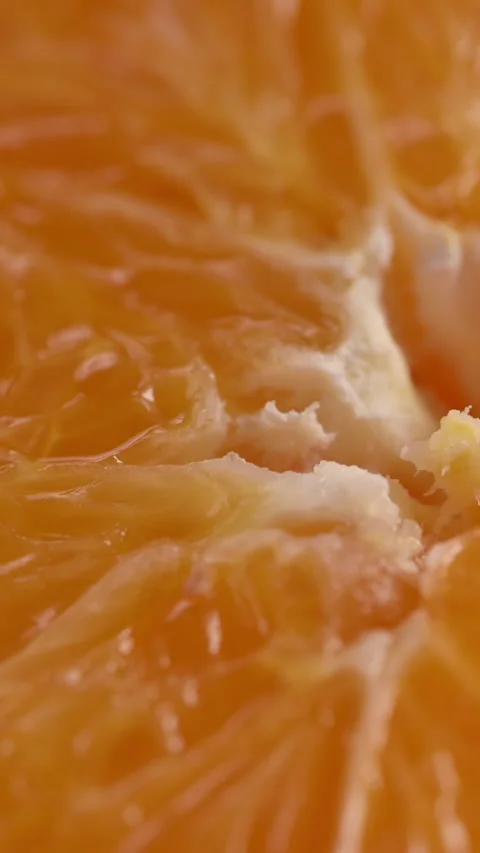 Orange slice revealed by moving light with warm dramatic mood Stock Footage 332218853