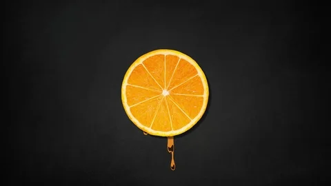 Orange slice rotating  with juice splash on black board background - animation Stock Footage 109196674