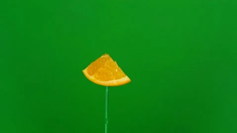 Orange slice spin on green screen Stock Footage 143550414