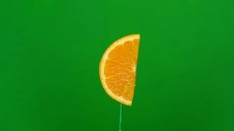 Orange slice spin on green screen Stock Footage 143550452