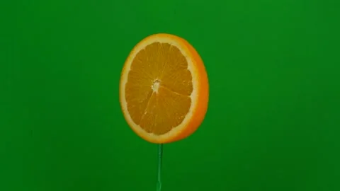 Orange slice spin on green screen Stock Footage 143557164