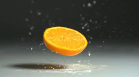 Orange slice splashing down in slow motion Stock-Footage 24738216