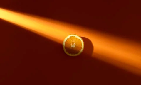 Orange slice in sunlight. Fresh slice of orange. Minimal image Stock Photos