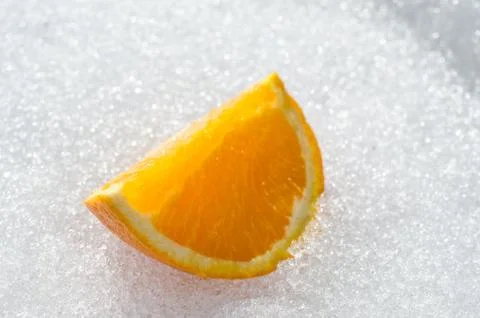 Orange slice on sunny easter snow in northern norway 写真素材