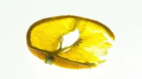 Orange slice  - time lapse drying out over a white back ground Stock Footage 65225319