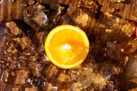 Orange slice on top of ice cubes Stock Photos