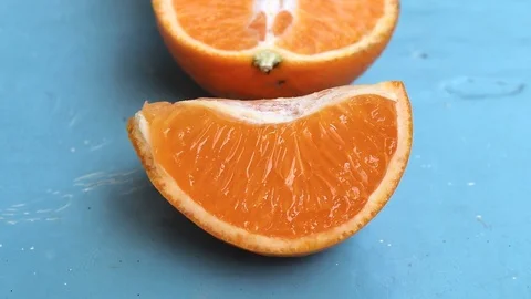 Orange slices on a blue background. Video stock 113859600