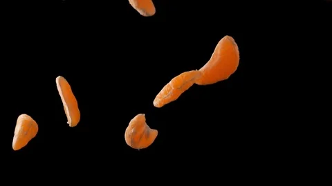 Orange slices falling on black background. Slow Motion. Stock Footage 84922227