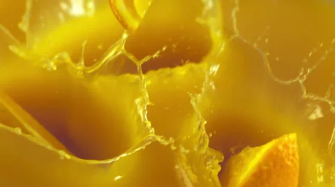 Orange slices falling into the orange juice Stock Footage 48360686