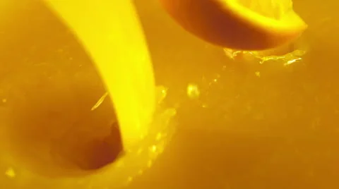 Orange slices falling into the orange juice Stock Footage 48391565