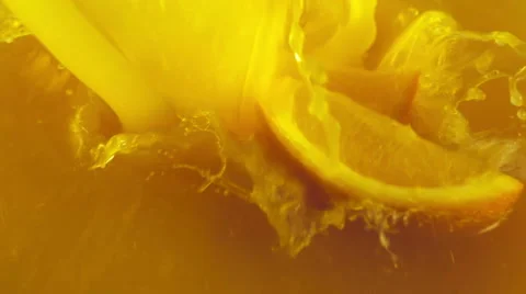 Orange slices falling into the orange juice Stock Footage 48391825
