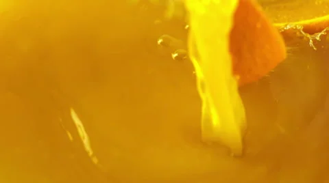 Orange slices falling into the orange juice Stock Footage 48417542