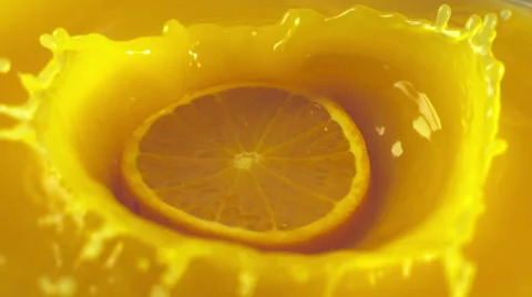 Orange slices falling into the orange juice Stock Footage 48431835