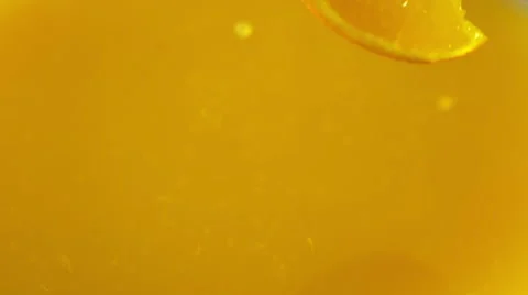 Orange slices falling into the orange juice Stock Footage 48434152