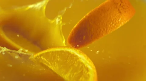 Orange slices falling into the orange juice Stock Footage 48445811