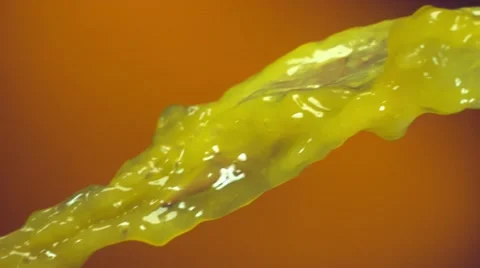 Orange slices falling into stream of orange juice Stock Footage 48546650