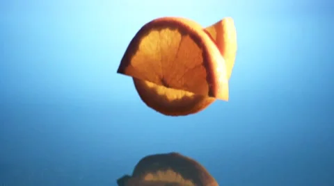 Orange slices falling into water Stock Footage 8572458