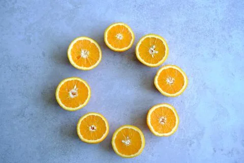 Orange Slices, half cut oranges on a marble background Stock Photos