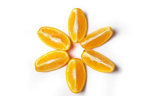 Orange slices ispread out in the form of the sun solated on white background. Stock Photos