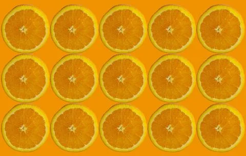 Orange slices pattern on isolated orange color background Stock Photos