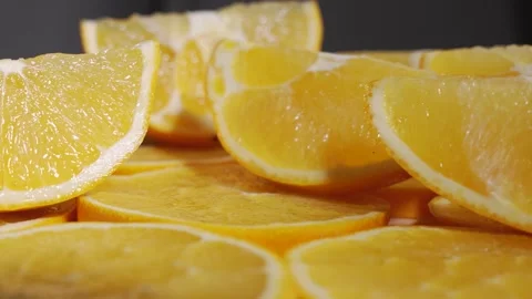 Orange slices rotate in a layered stack, with one round standing upright. Stock Footage 323222125