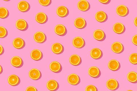 Orange slices seamless pattern on abstract pink background Stock Photos