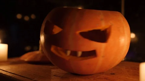 Orange small pumpkin on the cutting board in dark kitchen move Stock Footage 97379940