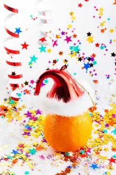 Orange in a small Santa hat Stock Photos