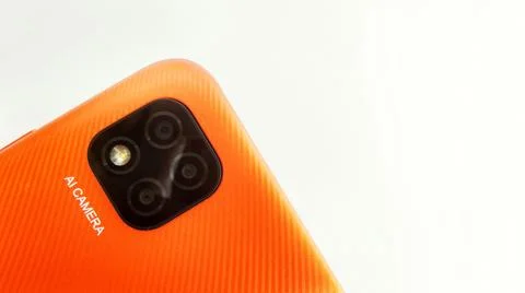 Orange smartphone with Artificial Intelligence (AI) cameras. Stock Photos