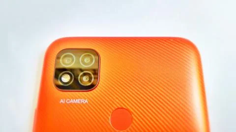 Orange smartphone with Artificial Intelligence (AI) cameras. Foto stock