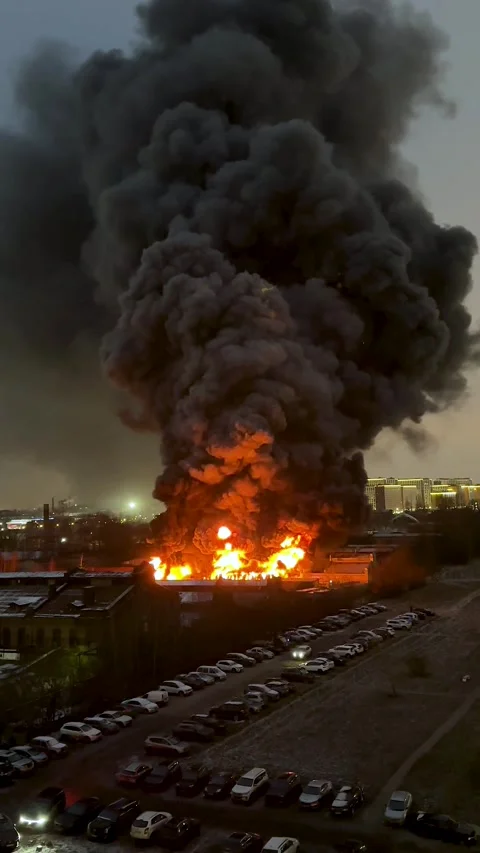 Orange smoke from flames or fires of warehouses and industrial building at night Stock Footage 295962468