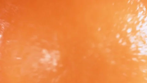Orange smoothie in blender with splashes, top view, close up, slow motion. Stock Footage 127157013