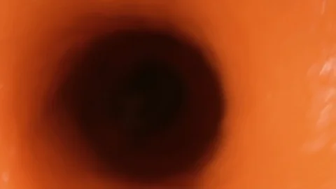 Orange smoothie is blending in blender with splashes, top view, close up. Stock Footage 127157407