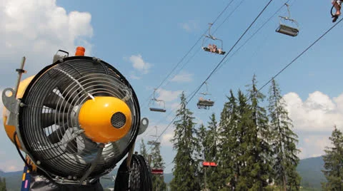 Orange Snow Gun Under Mountain Lift Video stock 26733052