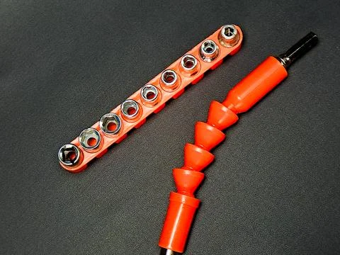 Orange socket set and flexible extension bar on dark texture offer tool ver.. Stock Photos