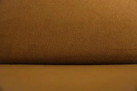 Orange sofa upholstery pattern, texture background. Stock Photos