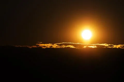 Orange solar disk and clouds closeup 스톡 사진