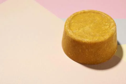 Orange solid shampoo bar on color background, closeup. Space for text Stock Photos