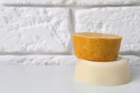 Orange solid shampoo bars on white table, closeup. Space for text Stock Photos