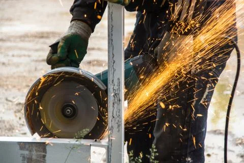 Orange sparks while cutting work done Stock Photos