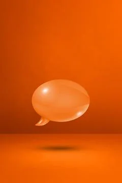 Orange speech bubble on concrete wall vertical background Illustrazione stock