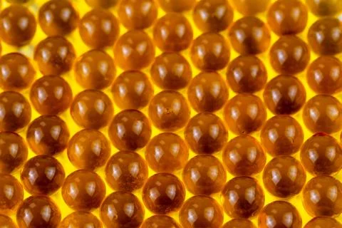 Orange spherical ball capsules of fish oil selective focus background Фото