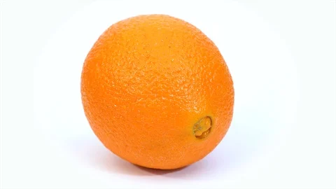 An orange is spinning around its axis on a white background.  Stock Footage 126757277