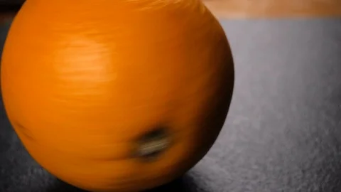 Orange spinning on dark background. Close up Stock Footage 116544836
