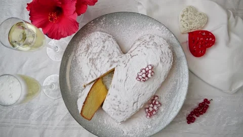 Orange sponge cake heart shaped on plate rotate. Pour champagne Valentines day. Stock Footage 259396060