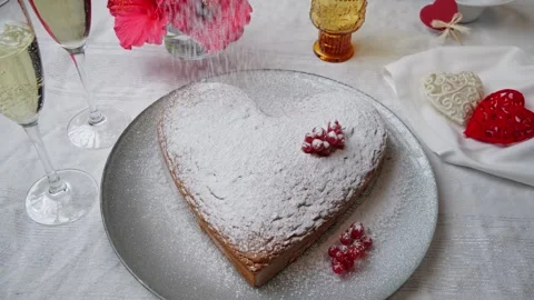 Orange sponge cake heart shaped on plate, powdered sugar. Valentines day. Stock Footage 259396064