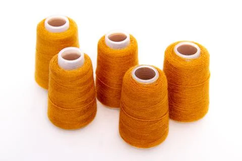 Orange spool of thread isolated on white background. Skein of woolen threads Stock Photos
