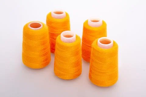 Orange spool of thread isolated on white background. Skein of woolen threads Stock Photos