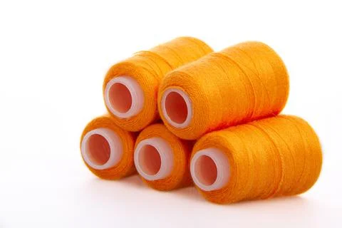 Orange spool of thread isolated on white background. Skein of woolen threads Foto stock